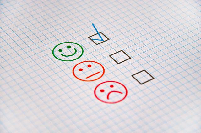 giving feedback with happy face or frown face